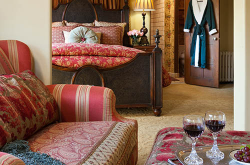 luxury suite at our monterey inn with bed and chair