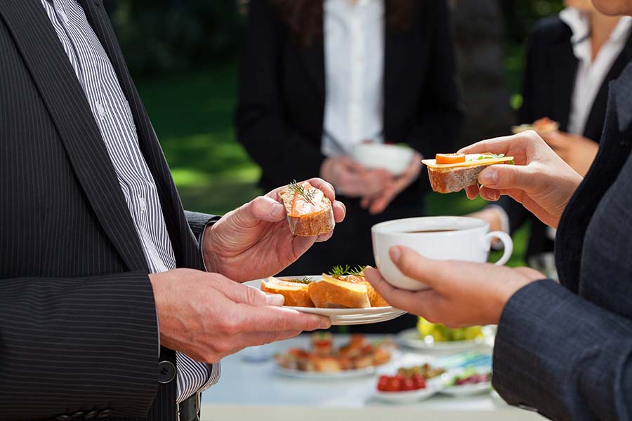 Business people who are eating lunch in the garden