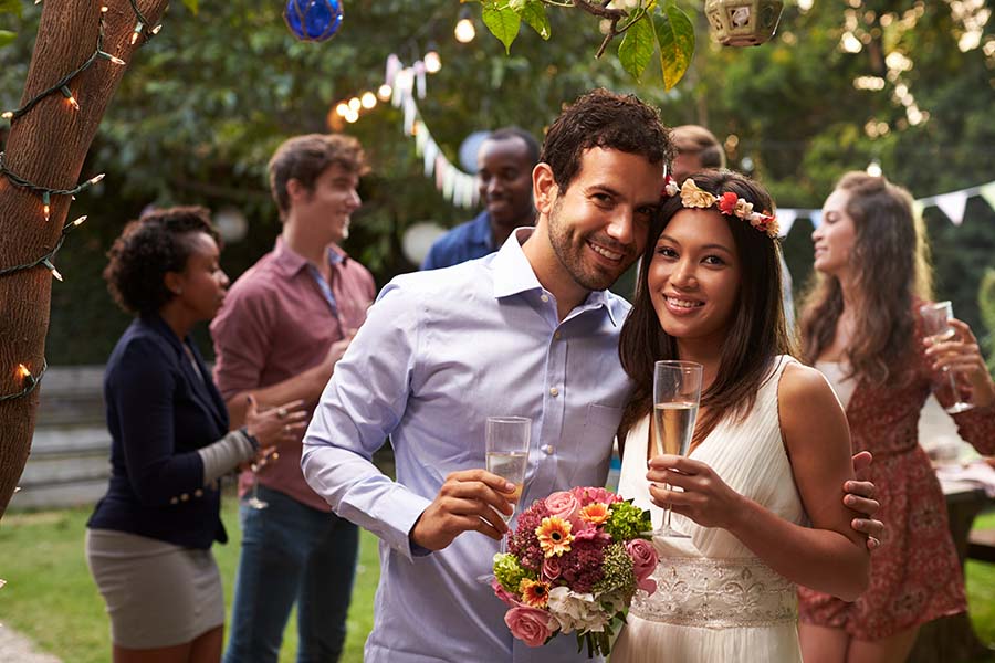 Portrait,Of,Couple,Celebrating,Wedding,With,Backyard,Party Portrait Of Couple Celebrating Wedding With Backyard Party