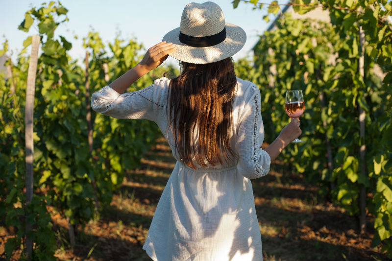 Woman standing in a vineyard at a top Monterey winery