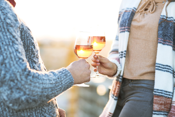 Two people with Wine Glassses on the Beach